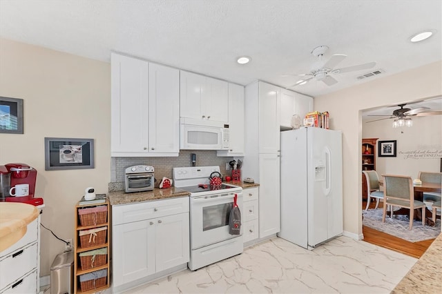 401 N Jefferson Ave, Sarasota, FL 34237 - kitchen with white appliances, ceiling fan, white cabinetry, decorative backsplash, and light marble finish flooring