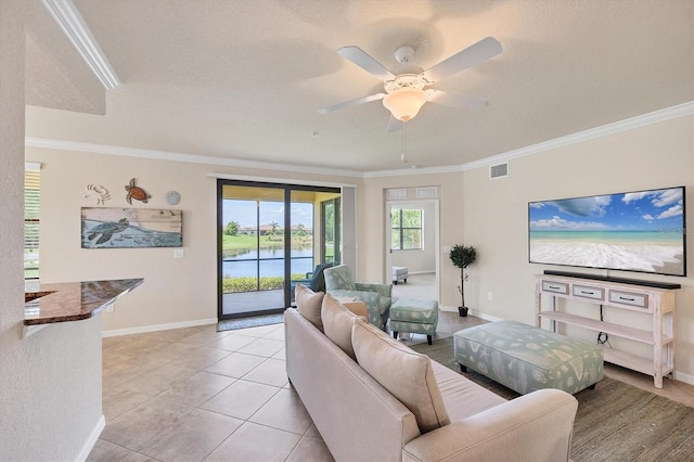 6512 Grand Estuary Trl Unit 101, Bradenton, FL 34212 - living room featuring ornamental molding, ceiling fan, and light tile patterned floors