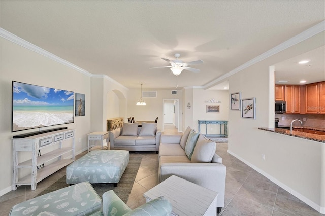 6512 Grand Estuary Trl Unit 101, Bradenton, FL 34212 - living room featuring ornamental molding, light tile patterned floors, ceiling fan, arched walkways, and recessed lighting