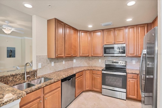 6512 Grand Estuary Trl Unit 101, Bradenton, FL 34212 - kitchen featuring stainless steel appliances, light stone countertops, a ceiling fan, backsplash, and light tile patterned floors