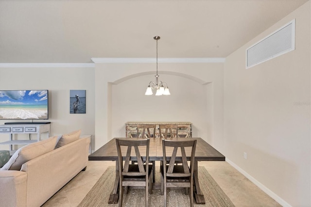 6512 Grand Estuary Trl Unit 101, Bradenton, FL 34212 - tiled dining room featuring a chandelier, ornamental molding, and arched walkways