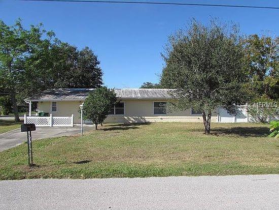 1105 17th Ave W, Palmetto, FL 34221 - view of front of house featuring a front yard and driveway