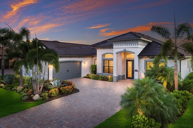 5804 Mulligan Way, Lakewood Ranch, FL 34211 - view of front of home featuring an attached garage, driveway, stucco siding, and a tiled roof