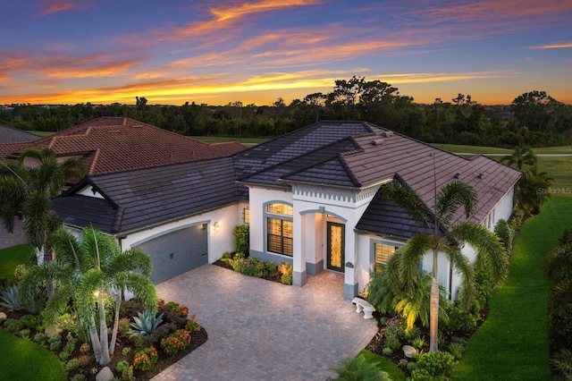 5804 Mulligan Way, Lakewood Ranch, FL 34211 - view of front facade featuring an attached garage, driveway, a tiled roof, and stucco siding
