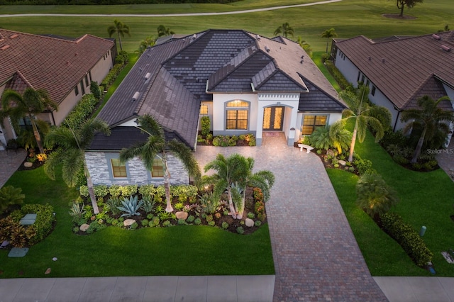 5804 Mulligan Way, Lakewood Ranch, FL 34211 - view of front facade with stucco siding, decorative driveway, stone siding, french doors, and golf course view