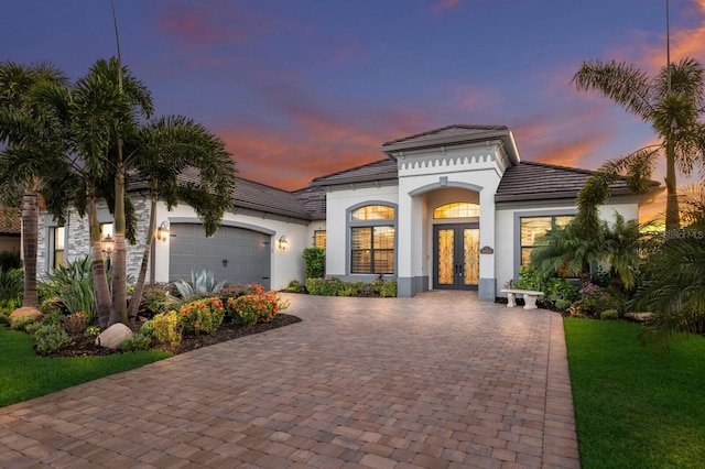 5804 Mulligan Way, Lakewood Ranch, FL 34211 - mediterranean / spanish-style home featuring french doors, an attached garage, decorative driveway, and stucco siding