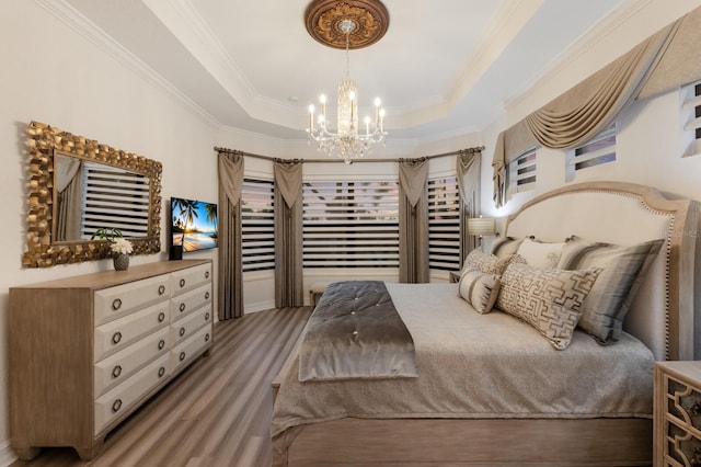 5804 Mulligan Way, Lakewood Ranch, FL 34211 - bedroom featuring a chandelier, ornamental molding, a raised ceiling, and light wood-style flooring