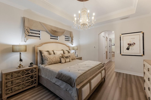 5804 Mulligan Way, Lakewood Ranch, FL 34211 - bedroom with arched walkways, wood finished floors, a raised ceiling, crown molding, and a chandelier