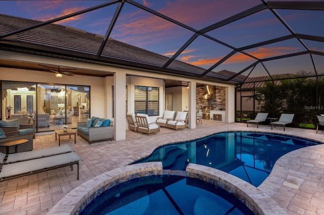 5804 Mulligan Way, Lakewood Ranch, FL 34211 - pool at dusk featuring an outdoor hangout area, a patio area, a pool with connected hot tub, and a ceiling fan