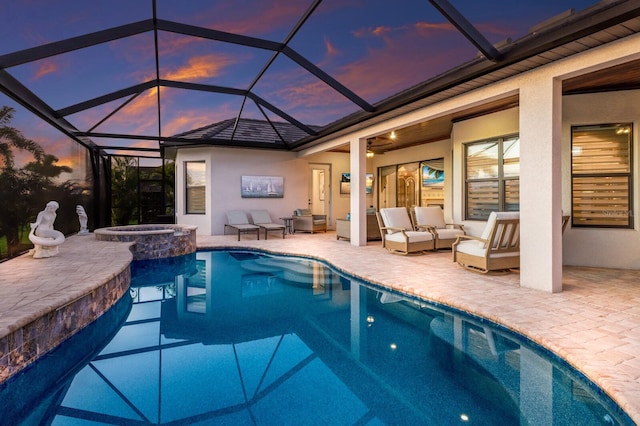 5804 Mulligan Way, Lakewood Ranch, FL 34211 - pool at dusk featuring an outdoor living space, a patio, and a pool with connected hot tub