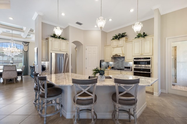 5804 Mulligan Way, Lakewood Ranch, FL 34211 - kitchen featuring cream cabinetry, stainless steel appliances, a chandelier, arched walkways, and recessed lighting