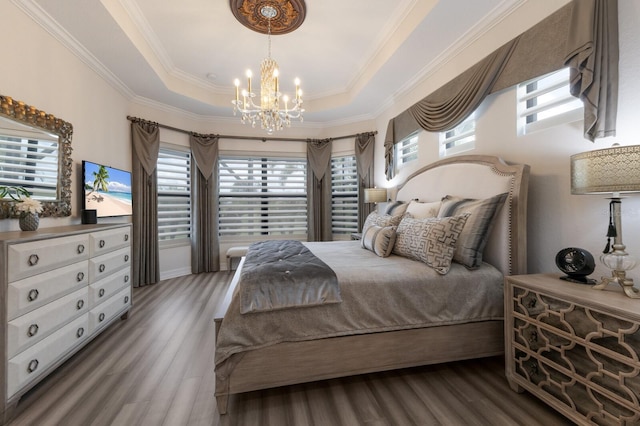 5804 Mulligan Way, Lakewood Ranch, FL 34211 - bedroom with a chandelier, wood finished floors, a raised ceiling, multiple windows, and crown molding