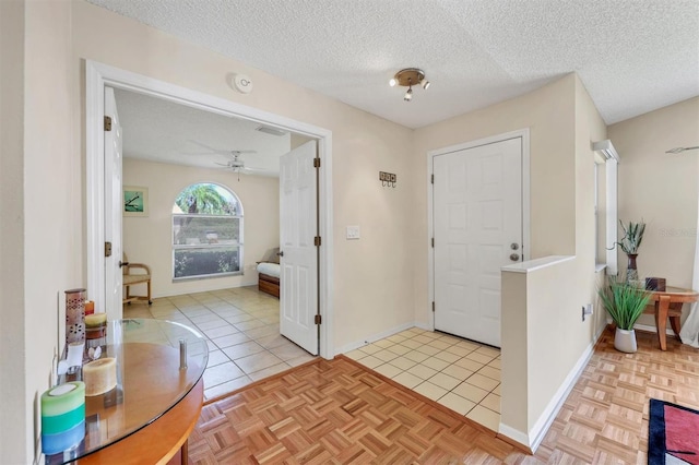 4107 Brittany Ln Unit 18, Sarasota, FL 34233 - foyer entrance with ceiling fan, a textured ceiling, and light tile patterned floors