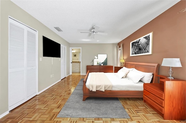 4107 Brittany Ln Unit 18, Sarasota, FL 34233 - bedroom featuring a textured ceiling, ensuite bath, and ceiling fan