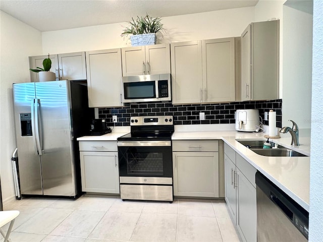 6253 Whetstone Ct, Palmetto, FL 34221 - kitchen with appliances with stainless steel finishes, gray cabinets, backsplash, and light countertops