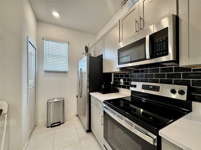 6253 Whetstone Ct, Palmetto, FL 34221 - kitchen featuring appliances with stainless steel finishes, tasteful backsplash, light countertops, and light tile patterned floors