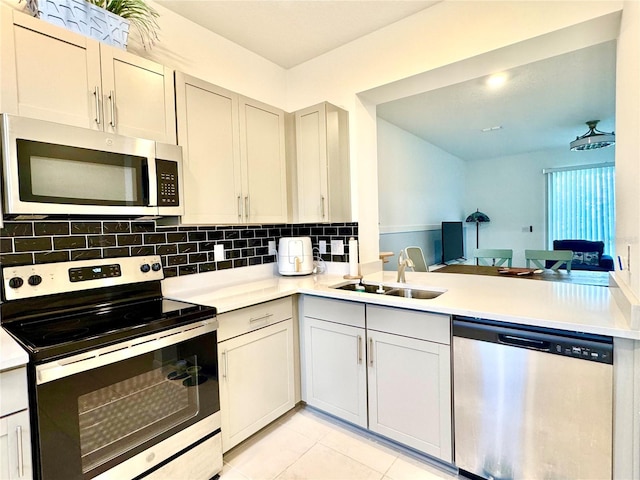 6253 Whetstone Ct, Palmetto, FL 34221 - kitchen with appliances with stainless steel finishes, decorative backsplash, and light countertops