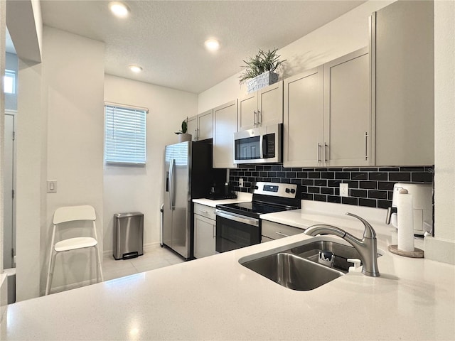6253 Whetstone Ct, Palmetto, FL 34221 - kitchen featuring stainless steel appliances, backsplash, gray cabinetry, light countertops, and recessed lighting