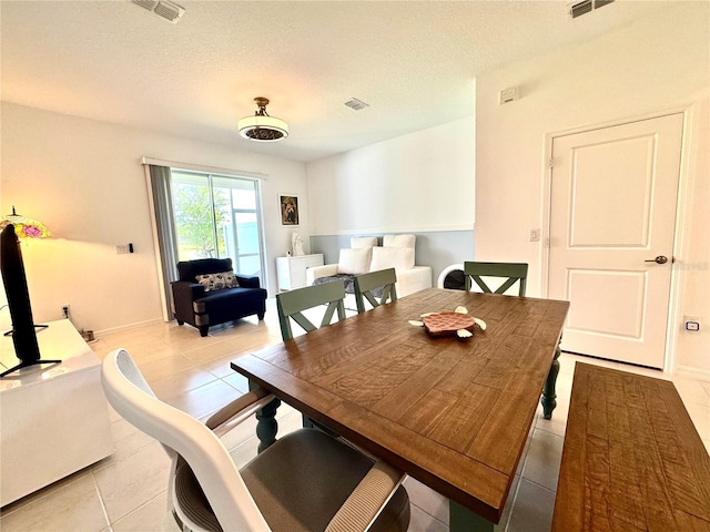 6253 Whetstone Ct, Palmetto, FL 34221 - dining area featuring light tile patterned floors and a textured ceiling