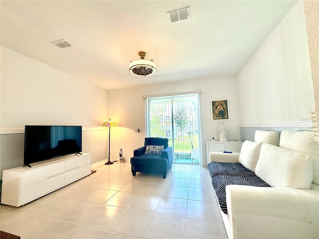 6253 Whetstone Ct, Palmetto, FL 34221 - tiled living room featuring a textured ceiling