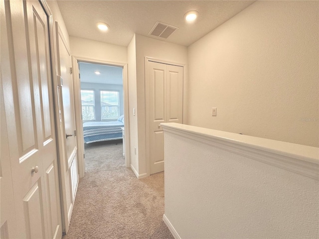 6253 Whetstone Ct, Palmetto, FL 34221 - hallway featuring light carpet, recessed lighting, and a textured wall
