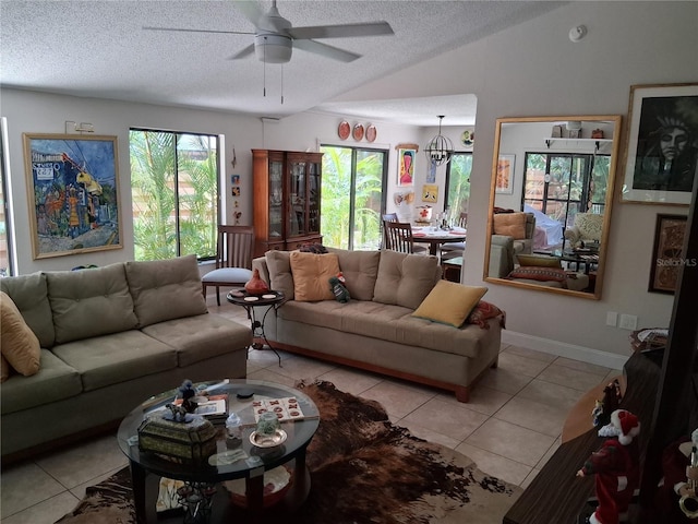 2411 Quail Ct, Bradenton, FL 34209 - living area with light tile patterned floors, ceiling fan, a textured ceiling, and lofted ceiling