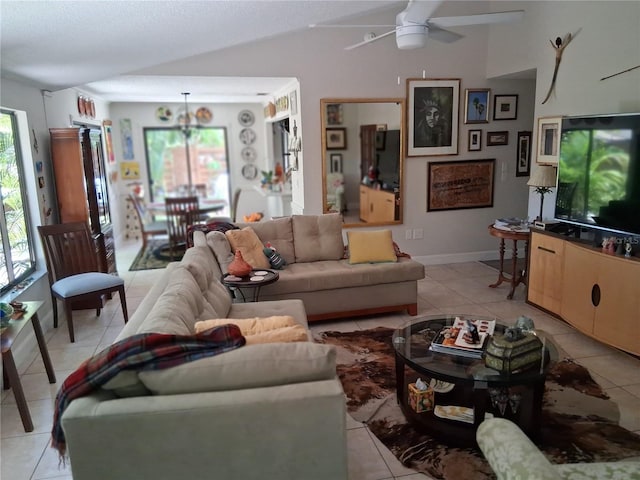 2411 Quail Ct, Bradenton, FL 34209 - living room featuring a ceiling fan, light tile patterned floors, vaulted ceiling, and a chandelier