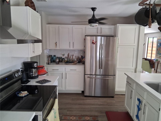 2411 Quail Ct, Bradenton, FL 34209 - kitchen with stainless steel appliances, ventilation hood, white cabinets, and light countertops
