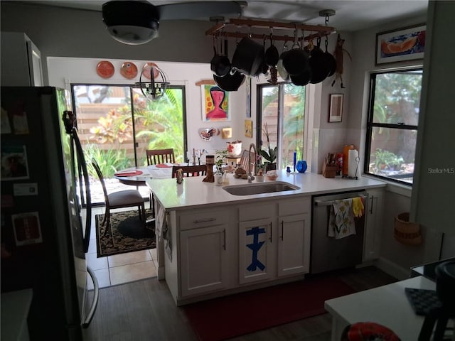 2411 Quail Ct, Bradenton, FL 34209 - kitchen featuring freestanding refrigerator, dishwasher, plenty of natural light, and light countertops