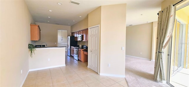 1251 Burgos Dr Unit 303, Sarasota, FL 34238 - kitchen featuring stainless steel appliances, dark countertops, light tile patterned flooring, and recessed lighting