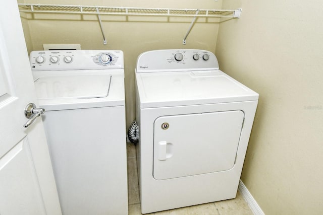 1251 Burgos Dr Unit 303, Sarasota, FL 34238 - laundry area featuring separate washer and dryer and baseboards