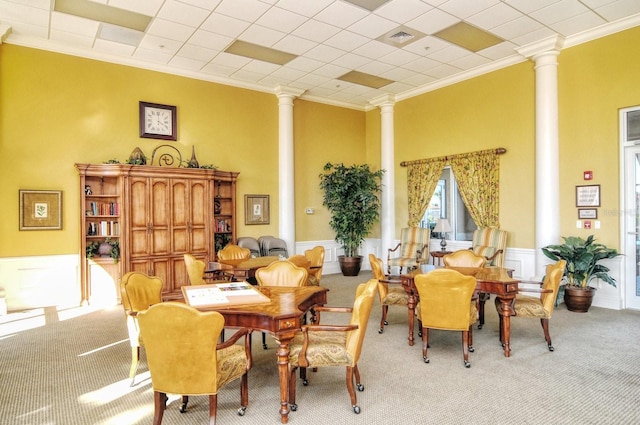 1251 Burgos Dr Unit 303, Sarasota, FL 34238 - living area featuring ornate columns, carpet floors, ornamental molding, a wainscoted wall, and a high ceiling