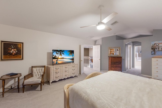 4410 67th Avenue Cir E, Sarasota, FL 34243 - bedroom with vaulted ceiling, light carpet, arched walkways, ensuite bathroom, and ceiling fan