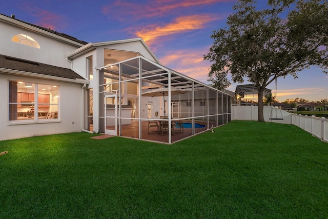 4410 67th Avenue Cir E, Sarasota, FL 34243 - back of property featuring stucco siding, a patio, a fenced backyard, and glass enclosure