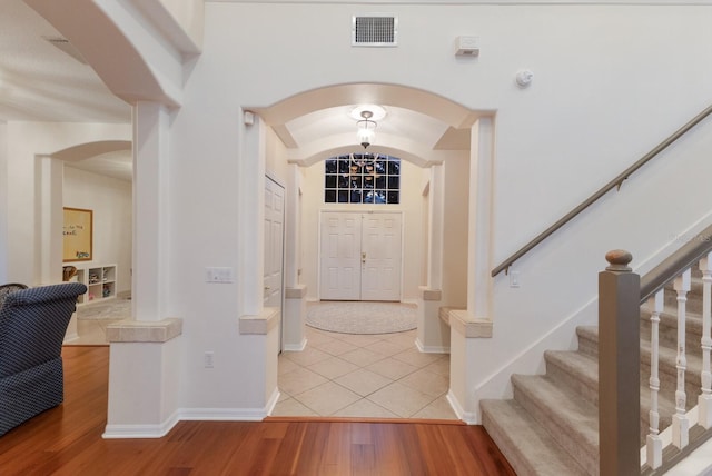 4410 67th Avenue Cir E, Sarasota, FL 34243 - foyer entrance with arched walkways, light wood finished floors, and stairway