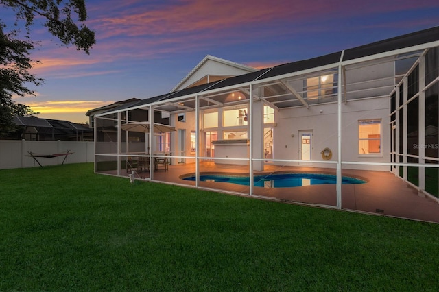 4410 67th Avenue Cir E, Sarasota, FL 34243 - back of property featuring a patio area, glass enclosure, and stucco siding