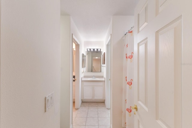 4410 67th Avenue Cir E, Sarasota, FL 34243 - hall featuring light tile patterned flooring and a sink