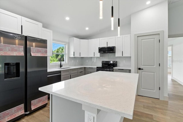 2692 Pretzel Ln, North Port, FL 34286 - kitchen with appliances with stainless steel finishes, tasteful backsplash, light stone countertops, light wood finished floors, and vaulted ceiling