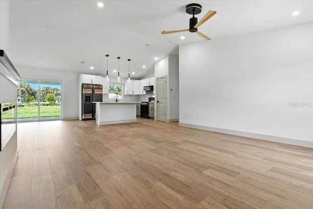 2692 Pretzel Ln, North Port, FL 34286 - unfurnished living room with lofted ceiling, recessed lighting, healthy amount of natural light, light wood-type flooring, and a ceiling fan