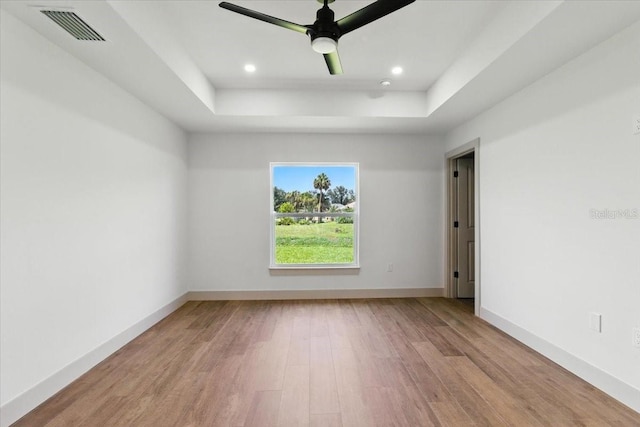 2692 Pretzel Ln, North Port, FL 34286 - empty room with a raised ceiling, wood finished floors, recessed lighting, and a ceiling fan