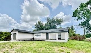 5009 Jody Ave, North Port, FL 34288 - view of front of home with an attached garage and a front yard