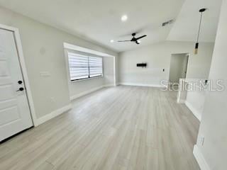 5009 Jody Ave, North Port, FL 34288 - unfurnished living room featuring a ceiling fan, light wood-style floors, and recessed lighting