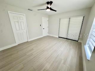 5009 Jody Ave, North Port, FL 34288 - unfurnished bedroom featuring wood finished floors and ceiling fan