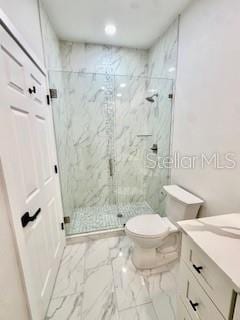 5009 Jody Ave, North Port, FL 34288 - bathroom featuring vanity, a marble finish shower, marble look tiles, and recessed lighting
