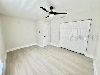 5009 Jody Ave, North Port, FL 34288 - unfurnished bedroom with wood finished floors and ceiling fan