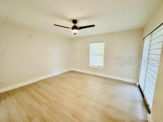 5009 Jody Ave, North Port, FL 34288 - empty room with wood finished floors and a ceiling fan