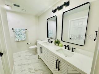 5009 Jody Ave, North Port, FL 34288 - bathroom with marble finish floors and double vanity