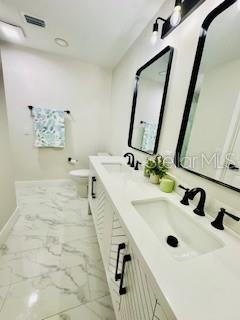 5009 Jody Ave, North Port, FL 34288 - full bathroom featuring marble finish flooring and double vanity
