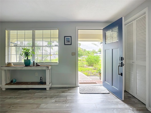 408 67th Ave W, Bradenton, FL 34207 - entrance foyer featuring plenty of natural light and wood finished floors