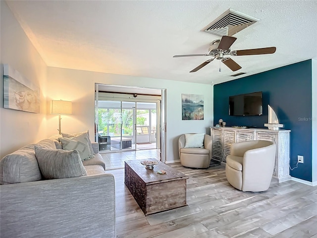 408 67th Ave W, Bradenton, FL 34207 - living room featuring ceiling fan, light wood-style floors, and a textured ceiling